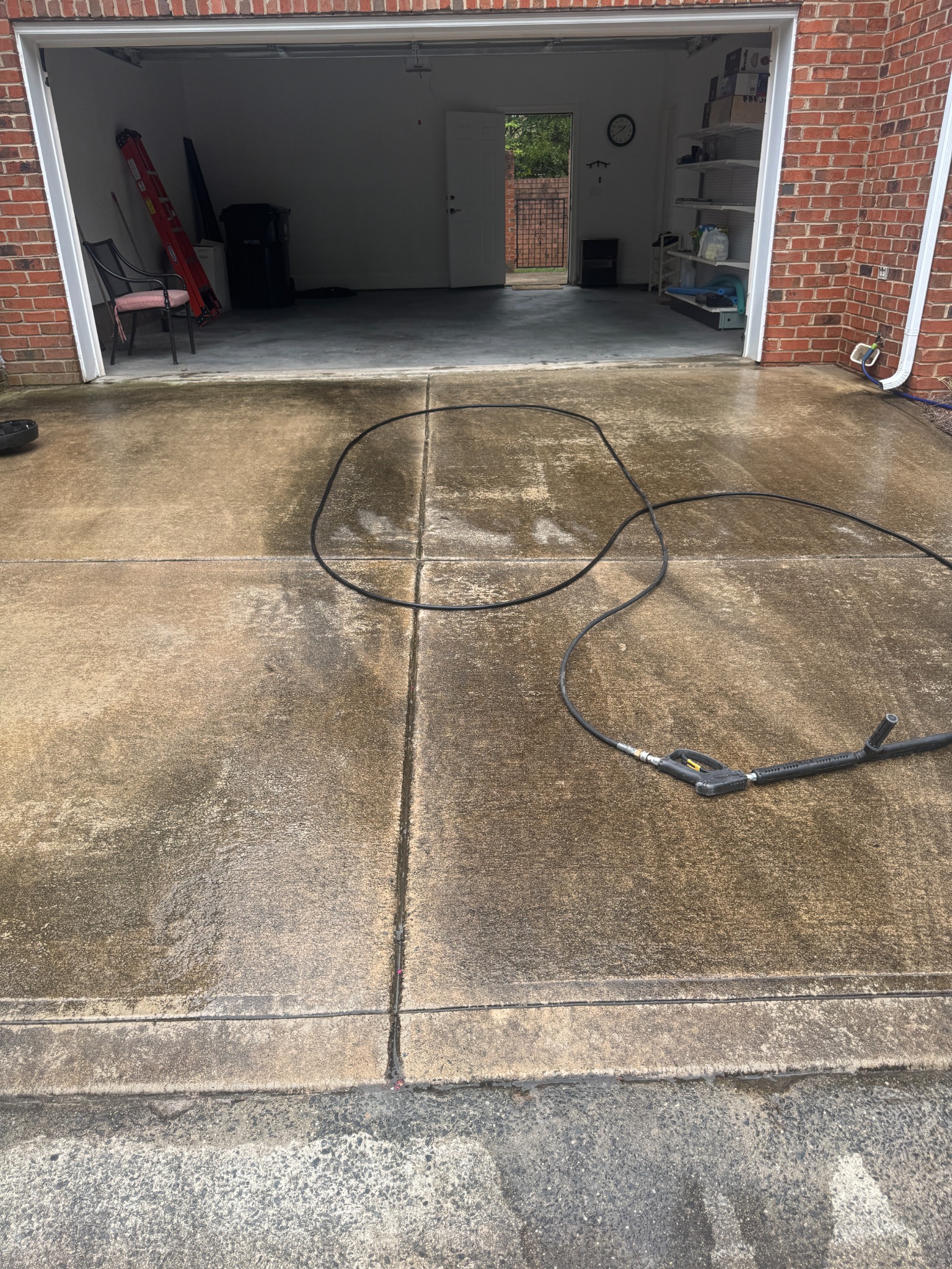 Driveway before cleaning, with dark surface buildup